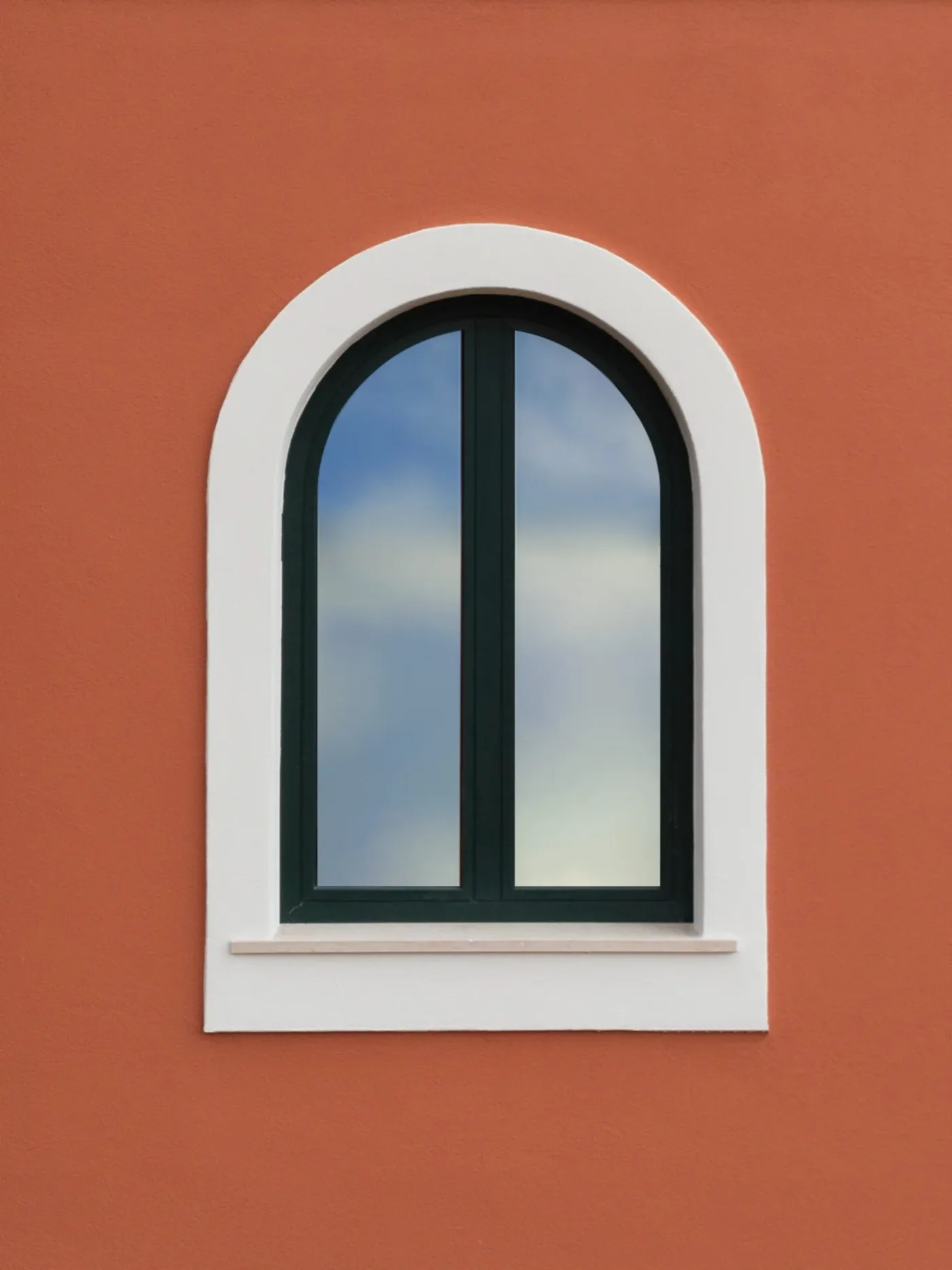An arched window on the terracotta facade